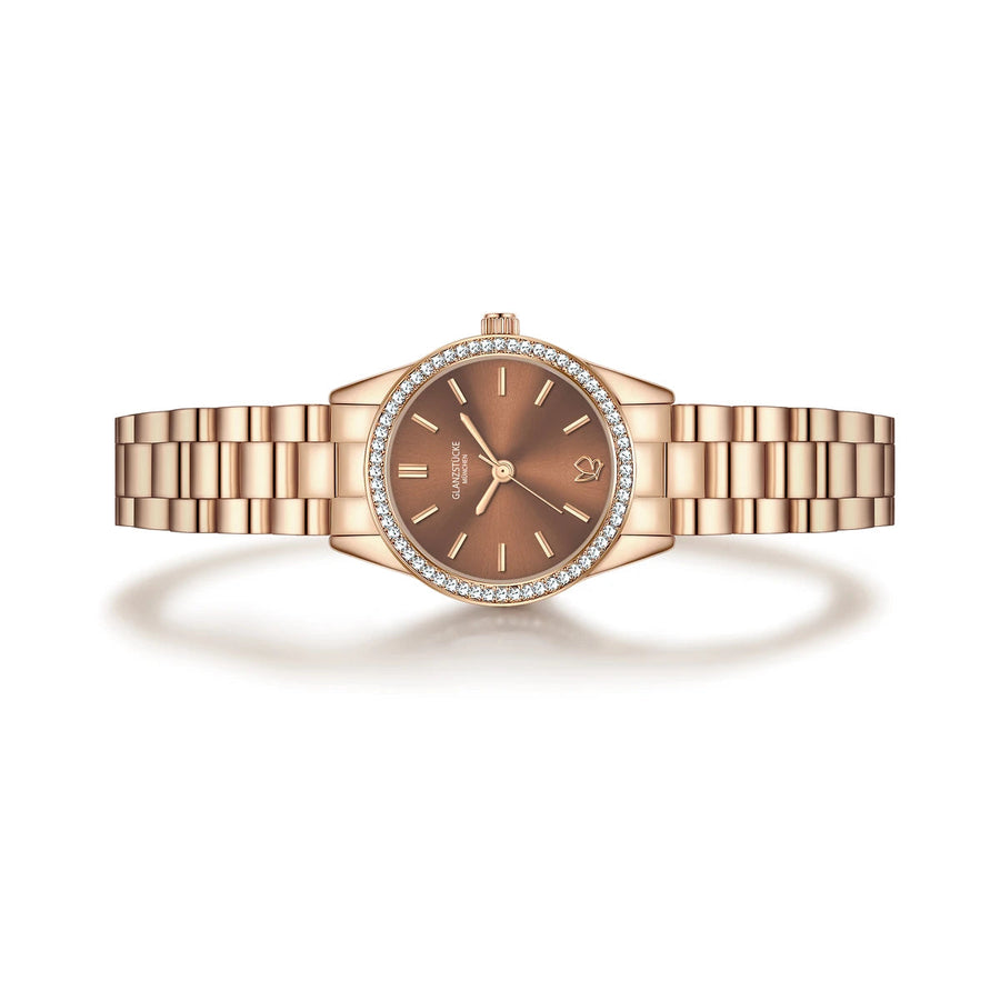 Roséfarbene Armbanduhr mit braunem rundem Zifferblatt.